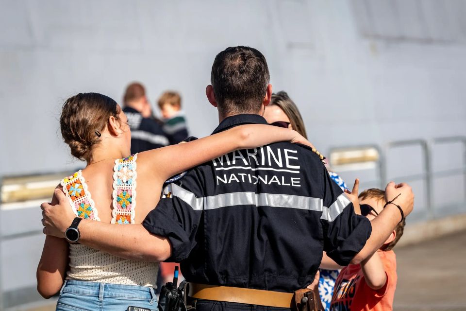 Un marin dit au revoir à sa femme et ses enfants sur le quai, avant de partir à bord d'un navire.