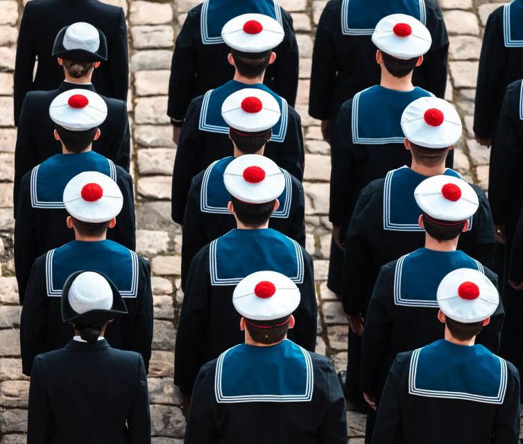 des matelots portant la coiffe avec pompon en rang pour une cérémonie