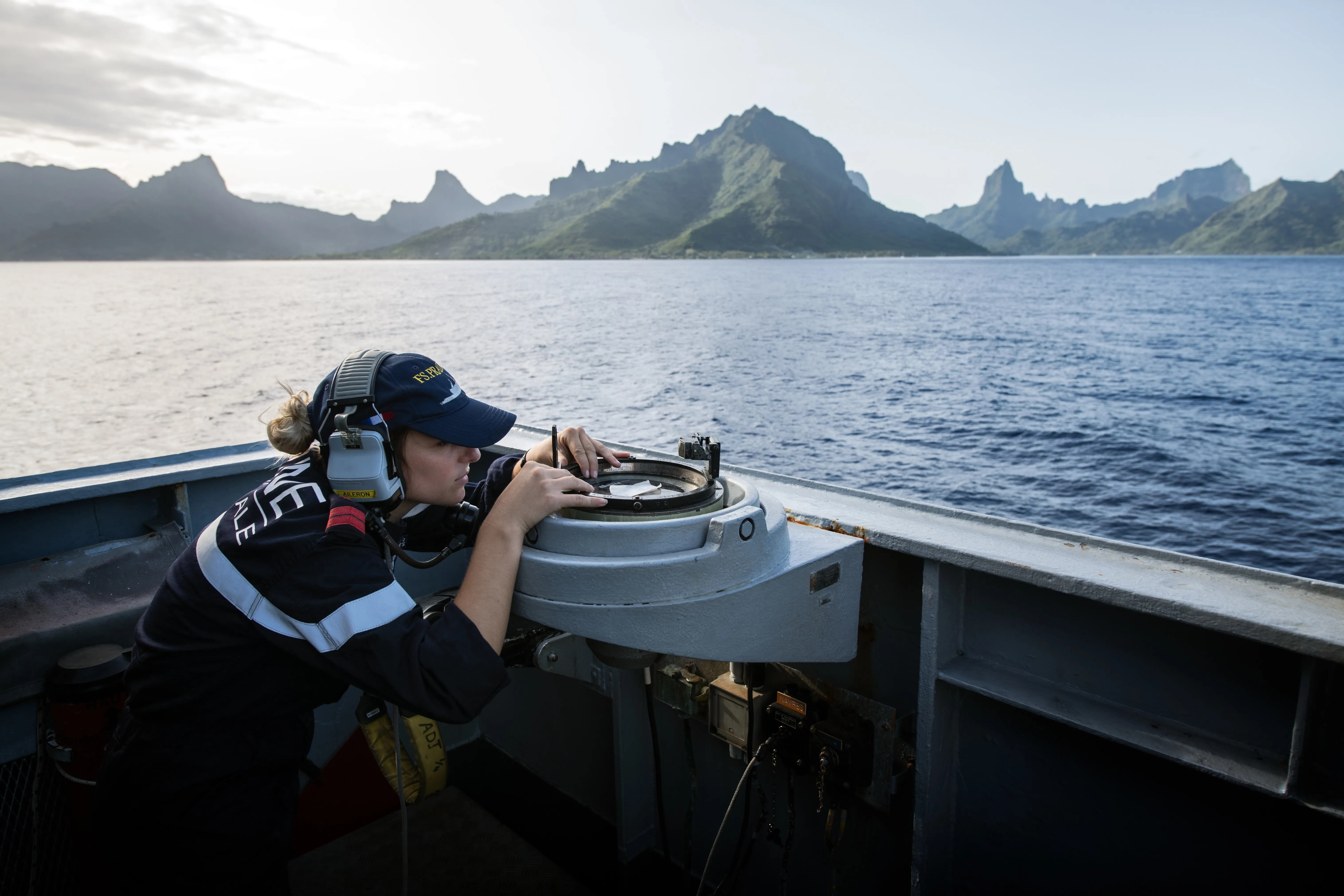 Une femme marin utilisant un compas de navigation pour établir la route de navigable
